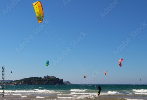 Kitesurfing or kiteboarding from the beach of Somo on a sunny windy afternoon Santander Cantabria Spain Summer 2020