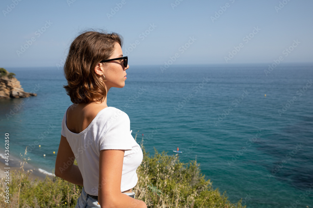 Natural beauty of as young lady in her vacation time enjoying her holidays in a beach of the coast side in a tourist location. 