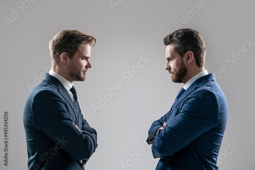 Valokuva two angry businessmen standing face to face having struggle for leadership, business competition