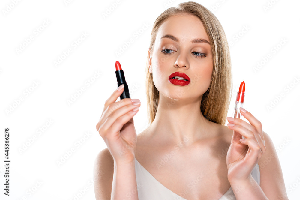 pretty young woman with red lips holding lipstick tubes isolated on white pretty young woman with red lips holding lipstick tubes isolated on white