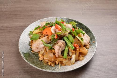 wok fried noodle phad Thai with chicken meat on wood background asian halal set lunch menu photo
