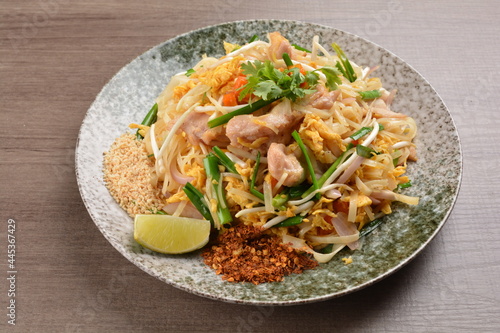wok fried noodle phad Thai with chicken meat on wood background asian halal set lunch menu