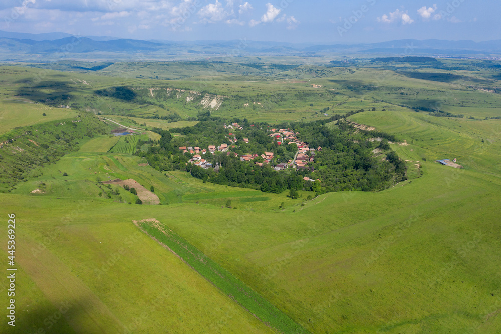 Flying over a village in Transylvania, Romania by drone