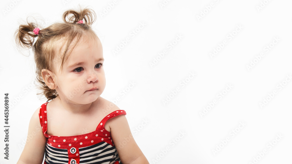 Studio portrait of cute, adorable, sad, upset, crying caucasian toddler girl in dress on isolated white background Studio portrait of cute, adorable, sad, upset, crying caucasian toddler girl in dress on isolated white background