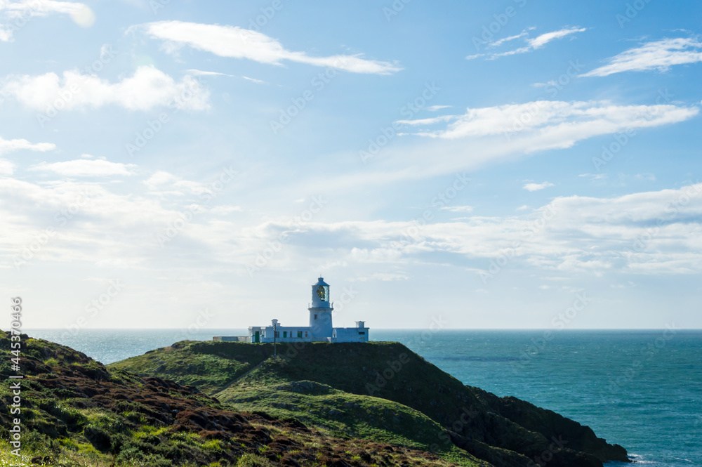 The lighthouse at Strumble Head, surrounded by the wild coastline and sea of Pembrokeshire. Wales.