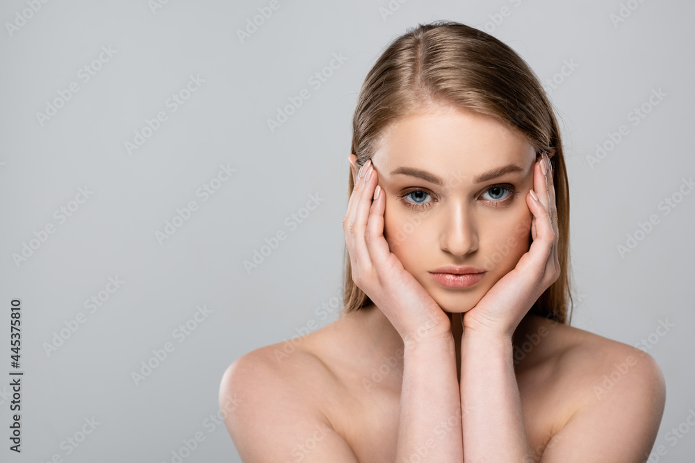 young woman with blue eyes touching face isolated on grey young woman with blue eyes touching face isolated on grey