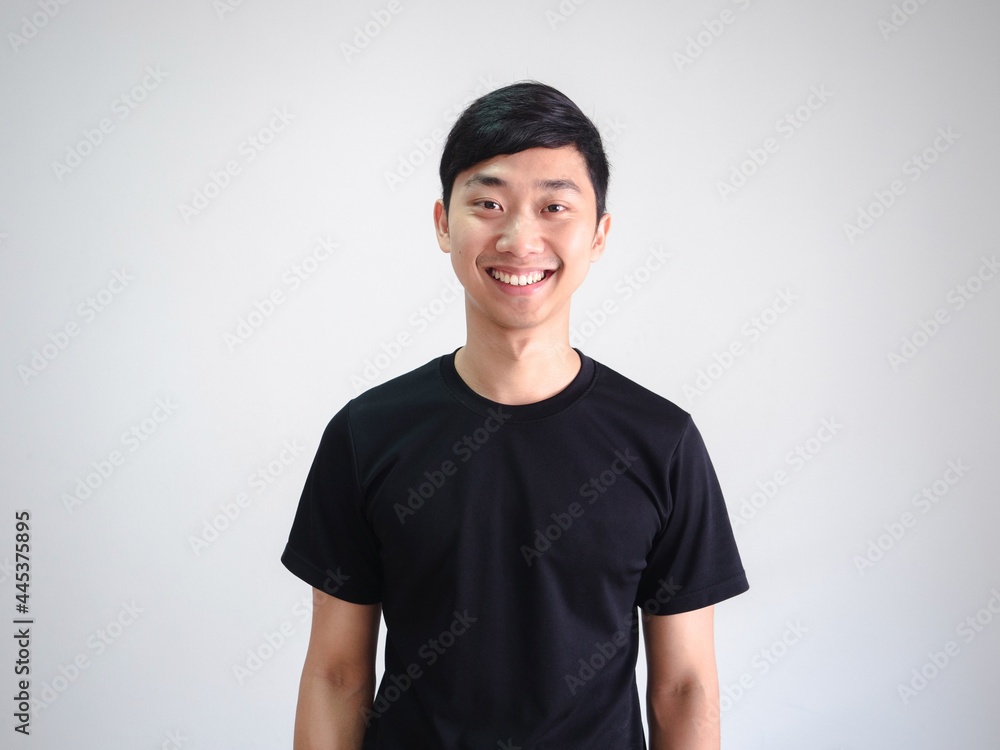 Young Thai man black shirt cheerful with happy smile look at camera crop half body portrait on isolated white Young Thai man black shirt cheerful with happy smile look at camera crop half body portrait on isolated white