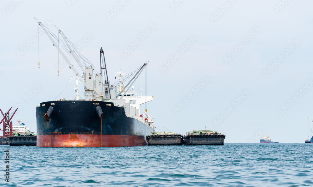 Crane in the industrial ship in the ocean blue water and blue sky landscape,Logistic and transportation ship concept in the sea