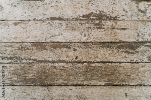 The texture of old scratched wood. Gray, worn paint on the wooden surface. Shabby wall background. Table top