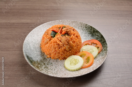 spicy chilli sambal chilli tomato wok fried rice nasi goreng on wood table asian halal menu