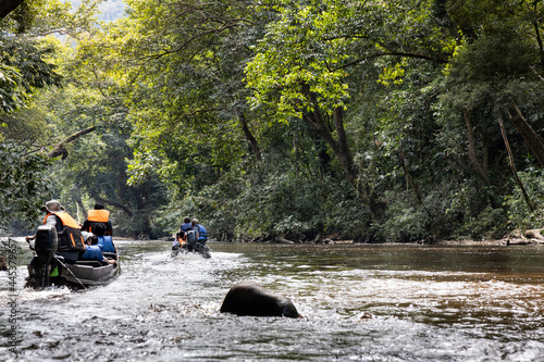River cruise along scenic Tahan River with lush rainforest foliage at Taman Negara National Park, Pahang