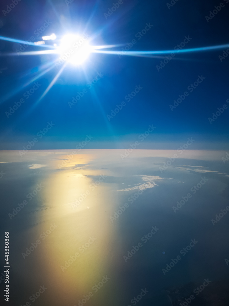 Aerial view from plane to morning sunrise over the ocean
