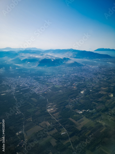 Aerial view from plane to cities and mountains in Italy