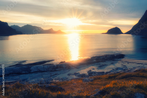 evening sunset on beach Haukland with white sand, and mountains the Lofoten Islands in polar Norway