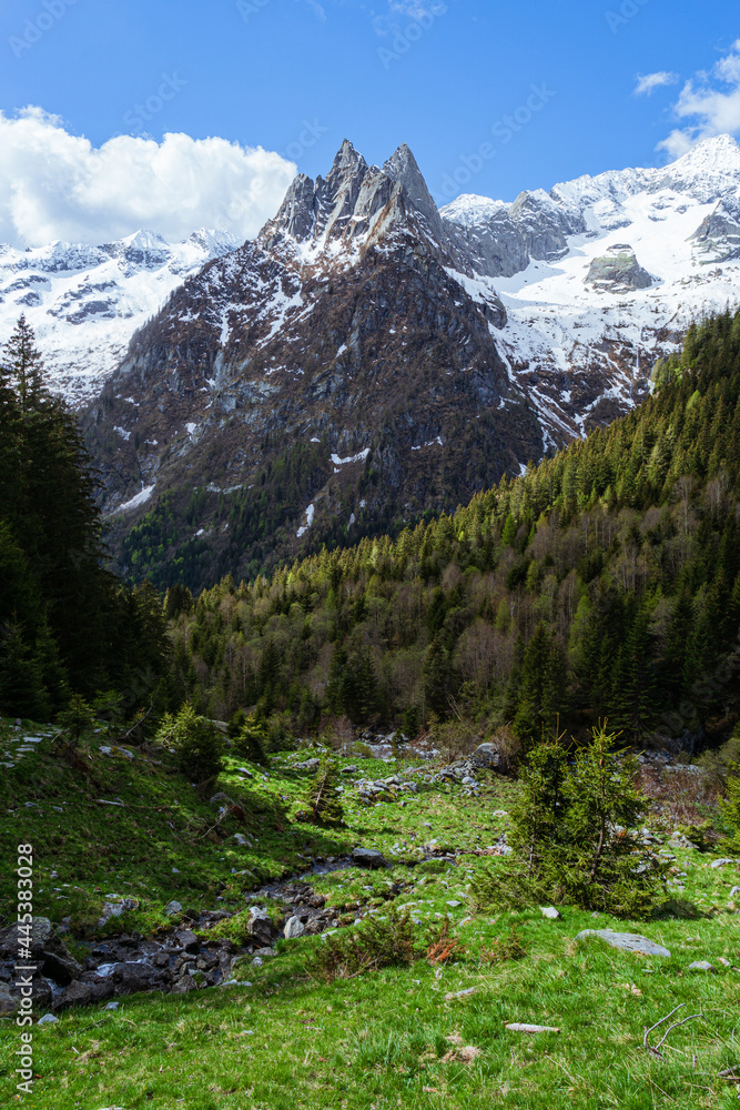 The snow-capped mountains of Val Masino, during spring in the Italian Alps, near the town of San Martino, Italy - May 2021.