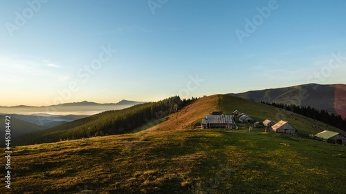 Beautiful nature landscape, amazing mountain view. Shepherd houses in the mountains at dawn