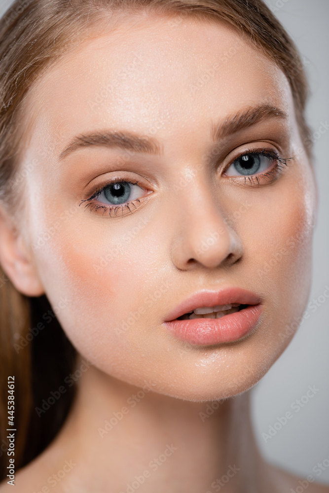 close up of young woman with perfect skin looking at camera isolated on grey close up of young woman with perfect skin looking at camera isolated on grey