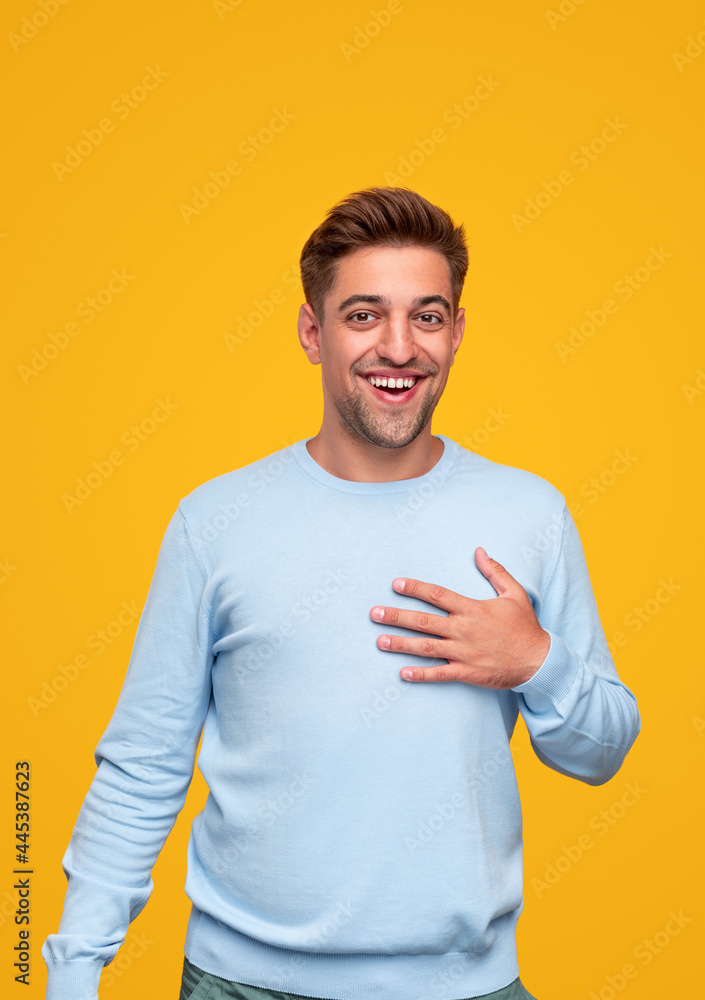 Pleased man touching chest in gratitude Pleased man touching chest in gratitude