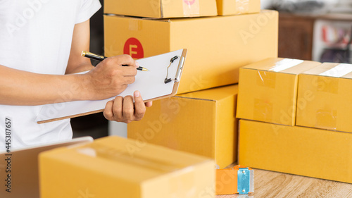 Start an SME business, online shopping working on laptop computer with parcel box at home - online SME business and delivery concept during coronavirus outbreak. © ArLawKa