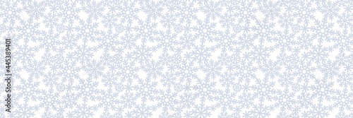 Long rectangular background with snowflakes. Seamless pattern on the theme of christmas  winter  snowfall. Gray silvery snow on white background. Endlessly repeating texture for fabrics  pillows  web.