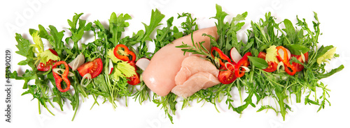 Raw Chicken Breast with fresh Rocket Salad Panorama isolated on white Background