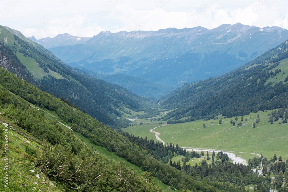 Landscape on a green valley in the Caucasus Mountains. The concept of local travel.