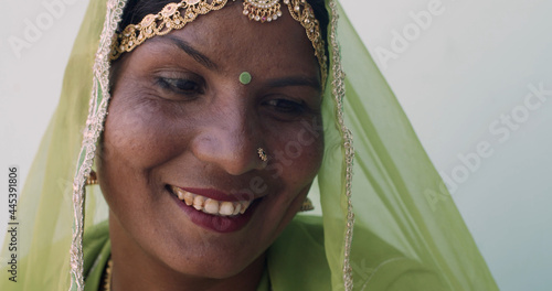 Indian female with green veil smiling on white background photo