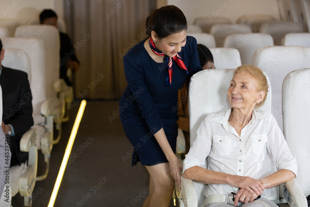 air hostess talking with senior passengers on airplane air hostess talking with senior passengers on airplane