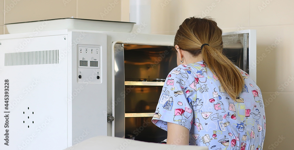 Sterilization of medical instruments for autoclaving. Back view of a