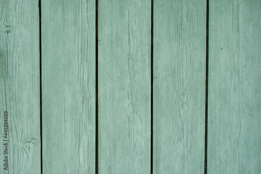 Obraz premium Natural wooden background made of boards painted in mint color. Paint for wooden surfaces