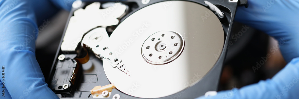 Gloved master holds computer hard drive closeup Gloved master holds computer hard drive closeup
