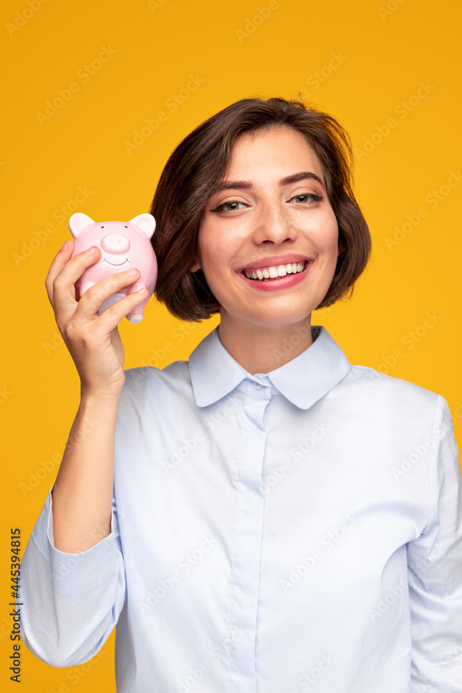 Happy young woman with piggy bank Happy young woman with piggy bank