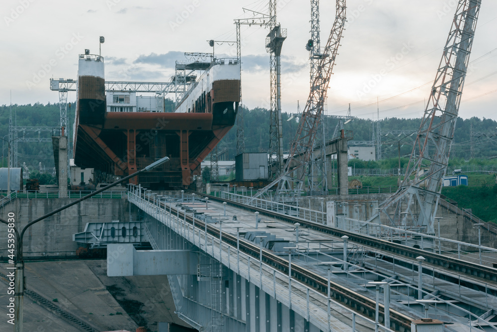 View of the ship lift against the backdrop of the sunset sky. Industrial background. View of the ship lift against the backdrop of the sunset sky. Industrial background.