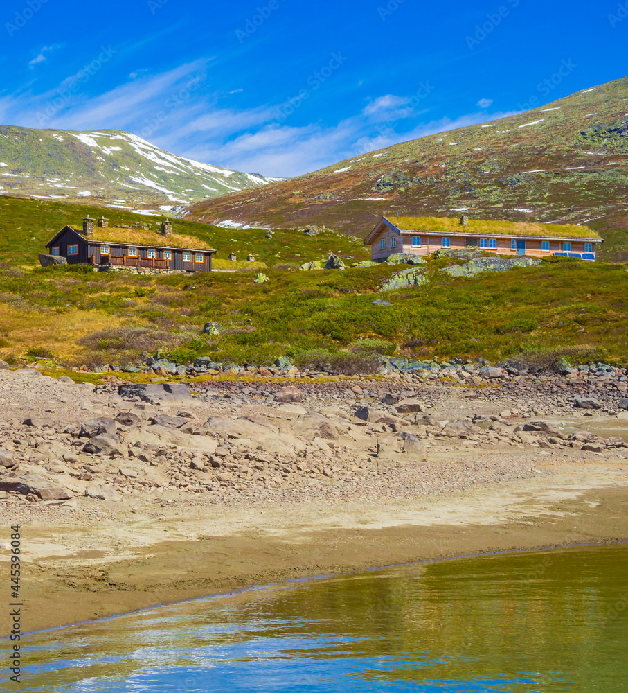 Vavatn lake panorama landscape cottages huts snowy mountains Hemsedal Norway.