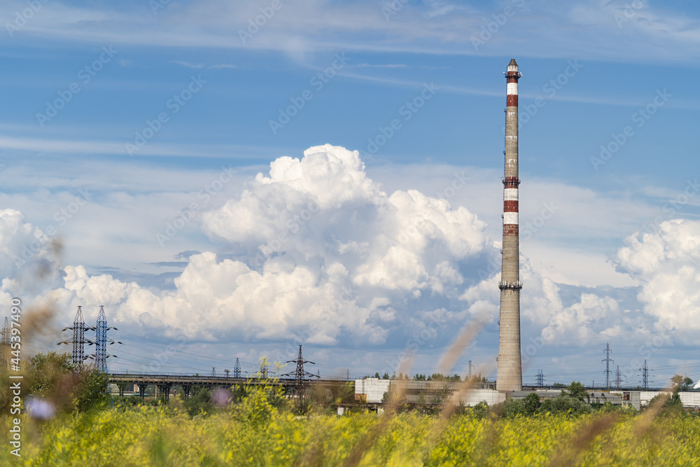 factory chimneys over the blue sky with white clouds factory chimneys over the blue sky with white clouds