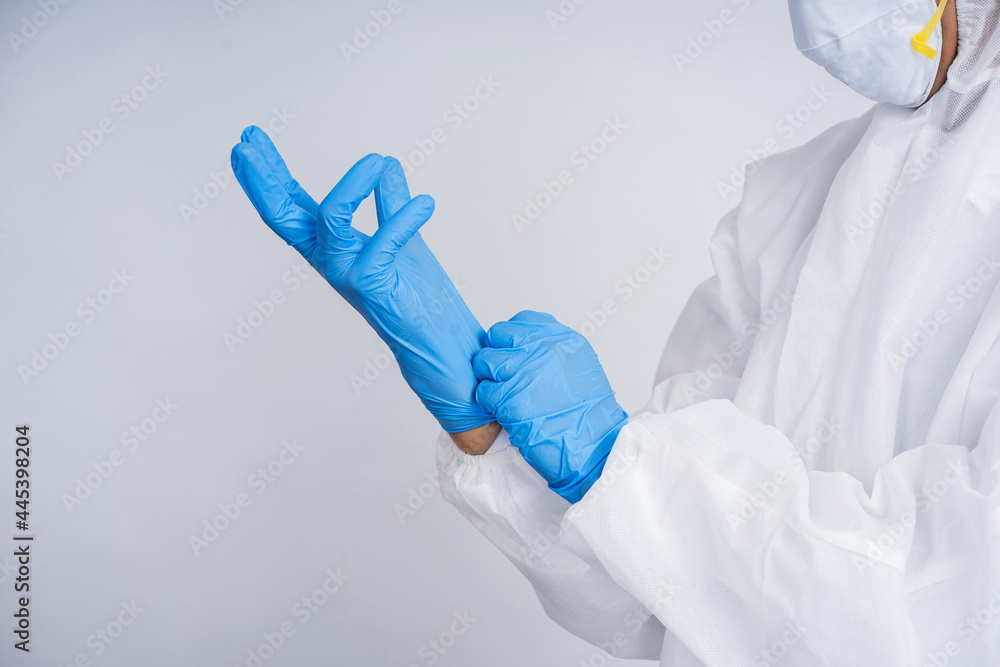 Fototapeta premium Close up of hands putting on medical gloves