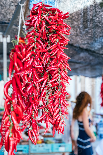 Peppers hung at a local flea market. Typical way of preserving peppers in Mallorca. Pebres enfilats photo