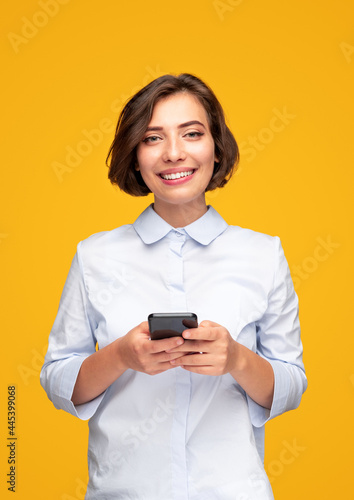 Cheerful young female using smartphone