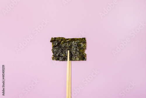 Small Crispy Nori Sheets Pink Background Healthy Japanese Snack Horizontal Bamboo Chopsticks