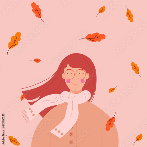 The girl is a redheaded autumn with falling leaves in a beige jacket and white scarf.
