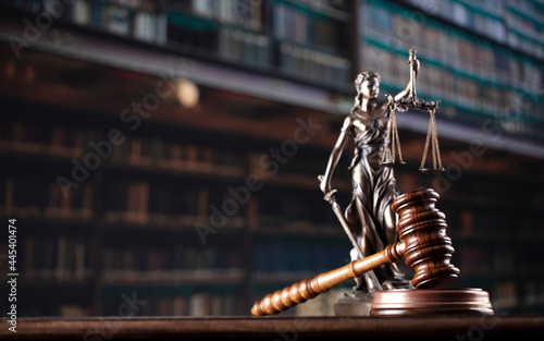 Law theme. Themis statue and judge gavel in the law faculty library.