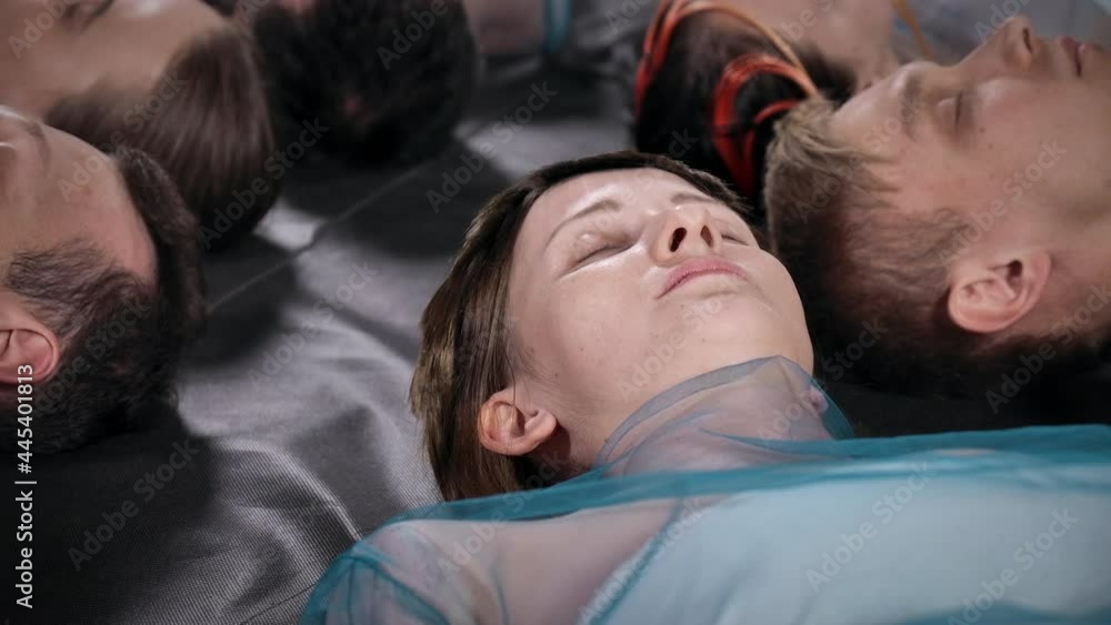 Video of lying men with their heads in the center of the circle Video of lying men with their heads in the center of the circle