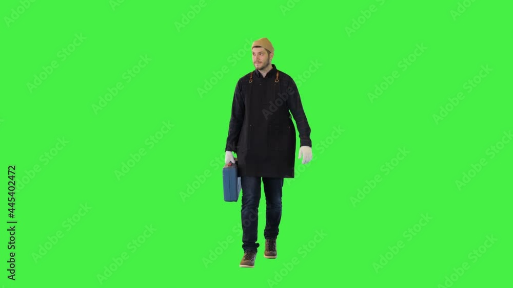 Young male construction worker carry toolkit Repairman or plumber service handyman with tool box on a Green Screen, Chroma Key. Young male construction worker carry toolkit Repairman or plumber service handyman with tool box on a Green Screen, Chroma Key.