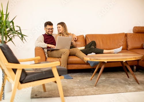 Young couple using laptop t...