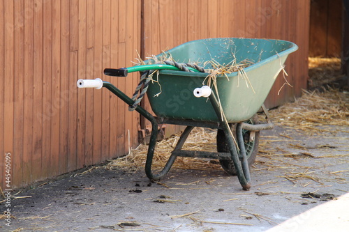 Fototapete A Mucking Out Wheelbarrow at a Riding Horse Stables.