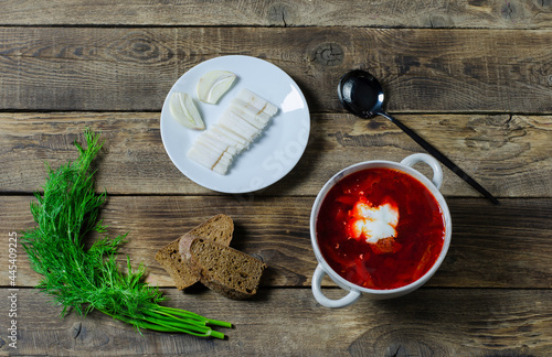 Russian or Ukrainian borsch or soup with sourcream on wooden background
