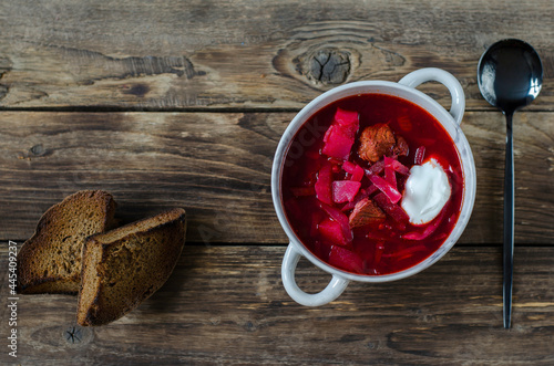 Russian or Ukrainian borsch or soup with sourcream on wooden background