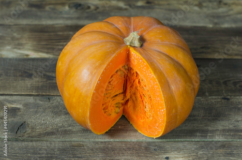 Orange pumpkin on wooden background
