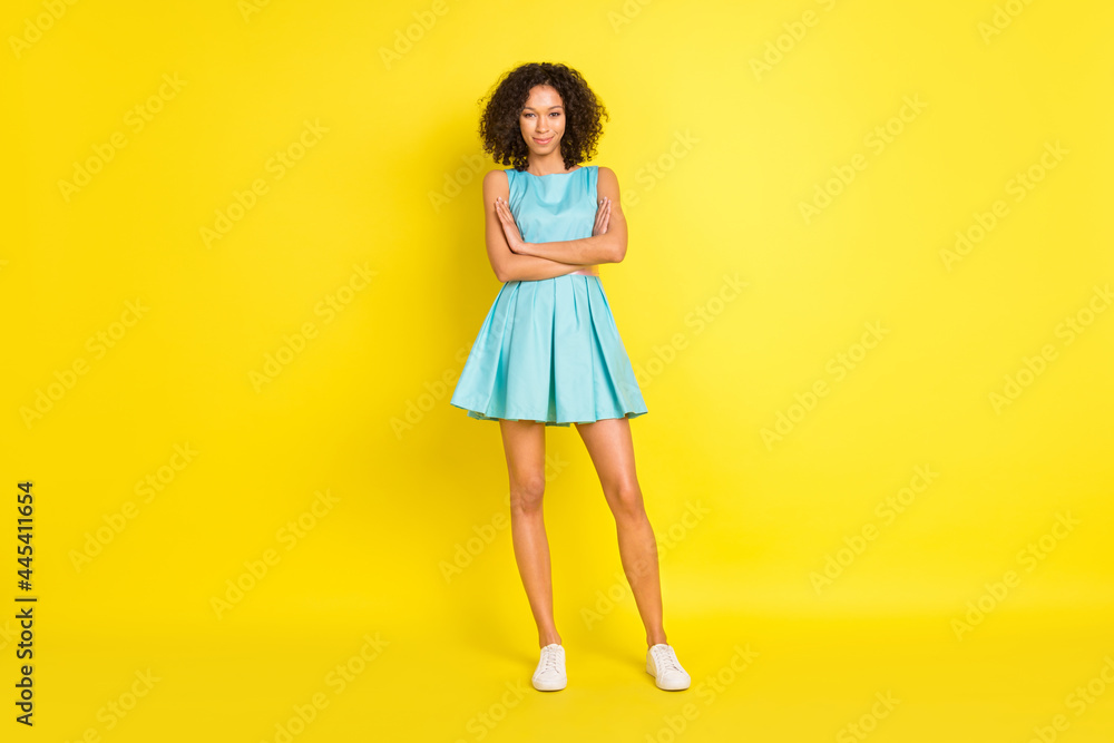 Full body photo of happy charming young afro american woman hold hands crossed isolated on yellow color background Full body photo of happy charming young afro american woman hold hands crossed isolated on yellow color background