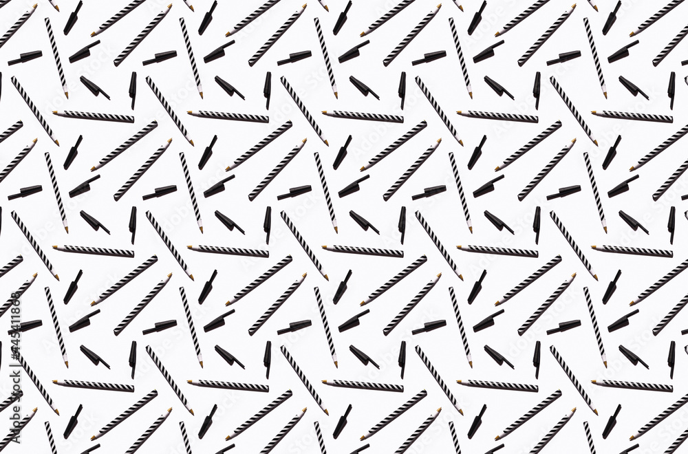 Pattern of black and white striped pens flat laid against white background Pattern of black and white striped pens flat laid against white background